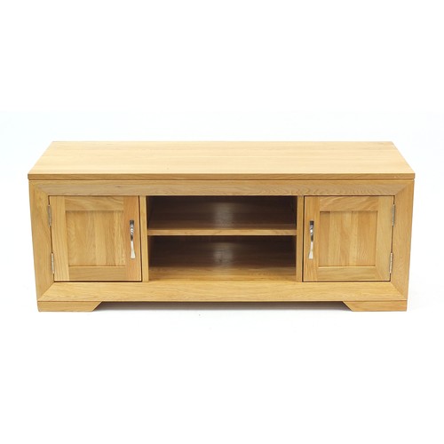 1029A - Light oak multimedia stand with a pair of cupboard doors and central shelf, 48cm H x 124cm W x 45cm ... 
