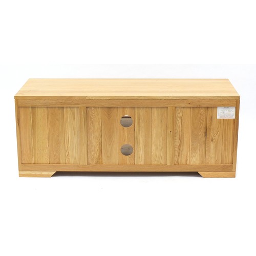 1029A - Light oak multimedia stand with a pair of cupboard doors and central shelf, 48cm H x 124cm W x 45cm ... 