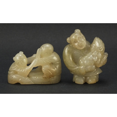 594 - Two Chinese celadon and russet jade carvings including one of a figure holding fruit, the largest 4.... 