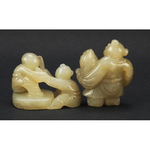 594 - Two Chinese celadon and russet jade carvings including one of a figure holding fruit, the largest 4.... 