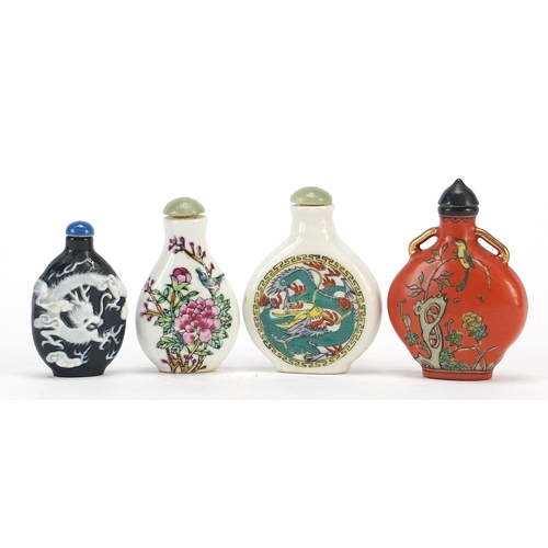 2423 - Four Chinese snuff bottles including a cameo glass example, the largest 7.5cm high