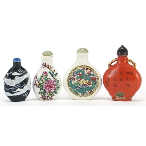 2423 - Four Chinese snuff bottles including a cameo glass example, the largest 7.5cm high