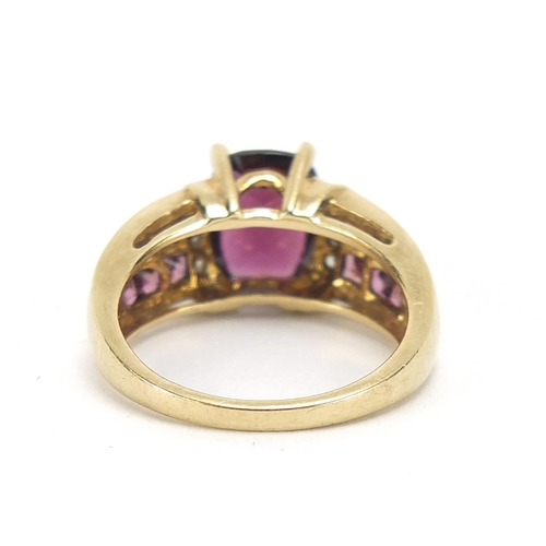 452 - 9ct gold diamond and purple stone ring, size K, 3.7g