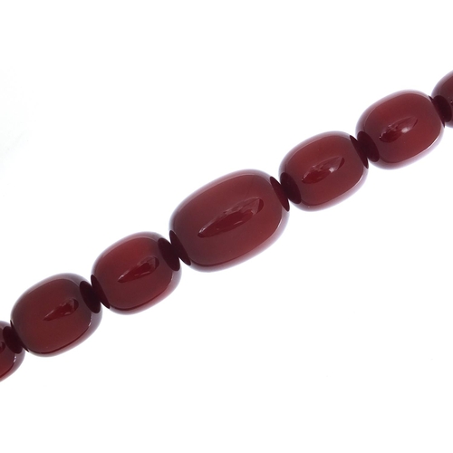 415 - Very large cherry amber coloured bead necklace,  the largest bead 4cm in length, 50cm in length, 200... 