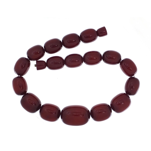 415 - Very large cherry amber coloured bead necklace,  the largest bead 4cm in length, 50cm in length, 200... 