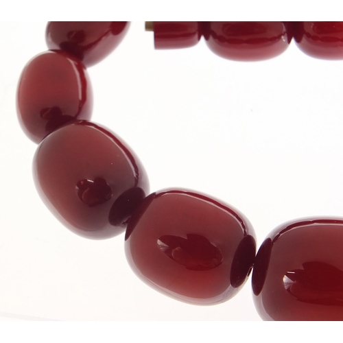 415 - Very large cherry amber coloured bead necklace,  the largest bead 4cm in length, 50cm in length, 200... 