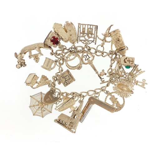 703 - Silver charm bracelet and a selection of mostly silver charms including Venetian gondola, gramophone... 