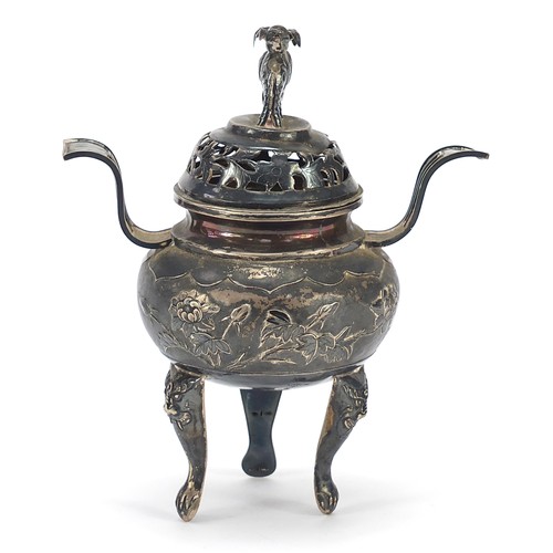 600 - Chinese silver three footed Koro with twin handles and a cover with elephant knop, embossed with flo... 