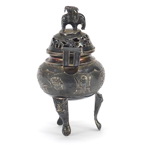 600 - Chinese silver three footed Koro with twin handles and a cover with elephant knop, embossed with flo... 