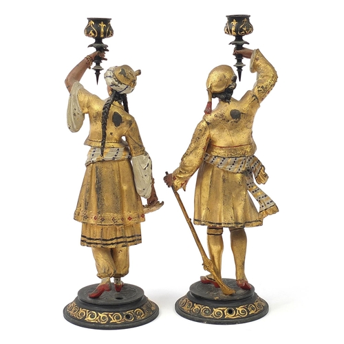 644 - Pair of cold painted spelter figural candlesticks of Middle Eastern figures wearing traditional dres... 