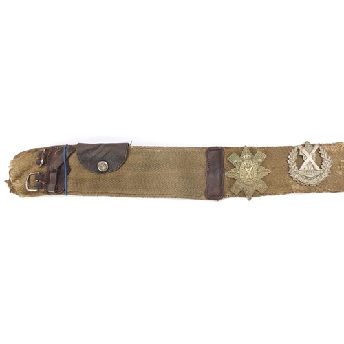 3502 - Five Scottish military interest cap badges arranged on a universal canvas belt including Scottish Ki... 