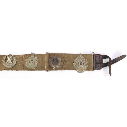 3502 - Five Scottish military interest cap badges arranged on a universal canvas belt including Scottish Ki... 