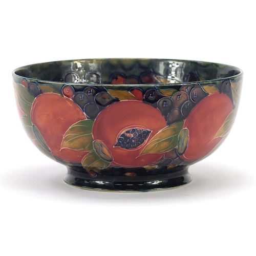566 - William Moorcroft Pomegranate pattern bowl, impressed and painted marks to the base, 21.5cm in diame... 
