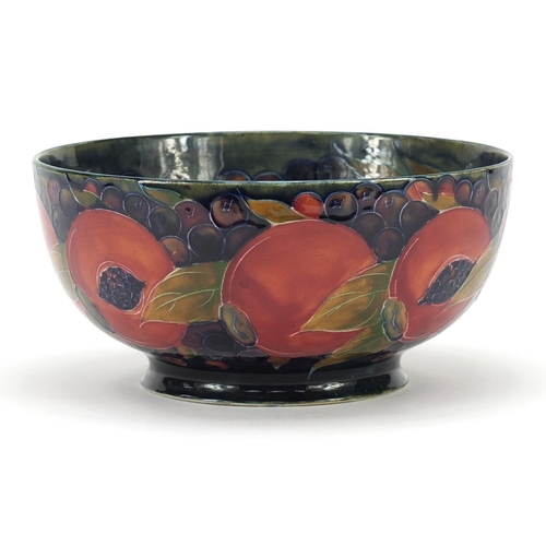 566 - William Moorcroft Pomegranate pattern bowl, impressed and painted marks to the base, 21.5cm in diame... 