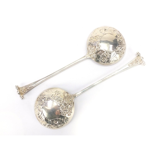 577 - Robinson & Co Ltd, pair of George V silver fruit spoons embossed with flowers and foliage, London 19... 