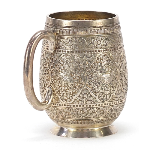 742 - William Hutton & Son, Victorian silver tankard profusely engraved in the Persian style with birds of... 