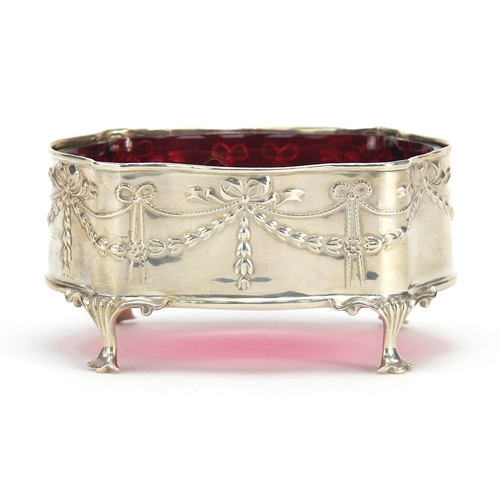 630 - Henry Matthews, George V silver and cranberry glass table salt embossed with swags and raised on fou... 