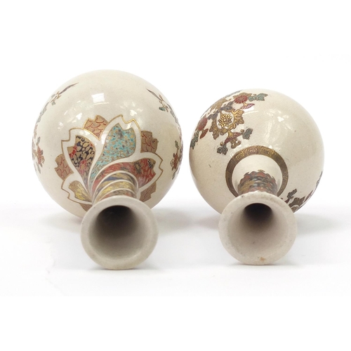 719 - Two Japanese Satsuma pottery bottle vases hand painted with flowers, the largest 18cm