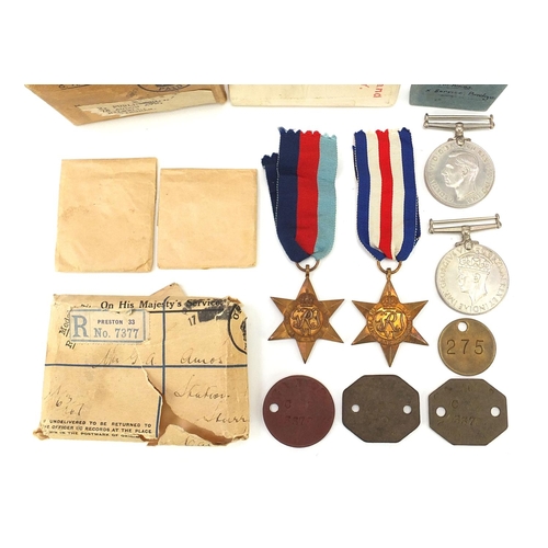 3457 - Four British military World War II medals and dog tags with two boxes