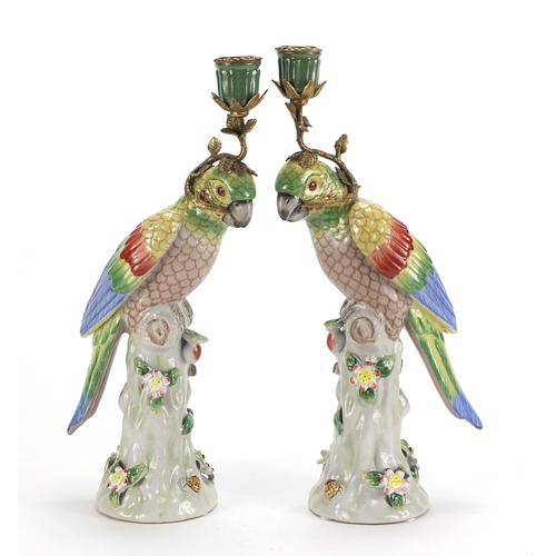 690 - Pair of continental porcelain parrot design candlesticks with bronze mounts, each 36cm high