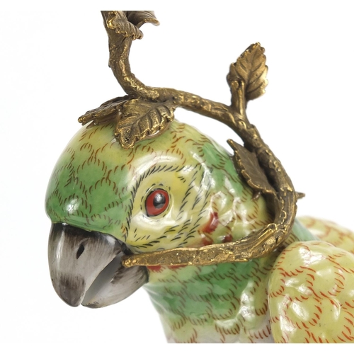 690 - Pair of continental porcelain parrot design candlesticks with bronze mounts, each 36cm high