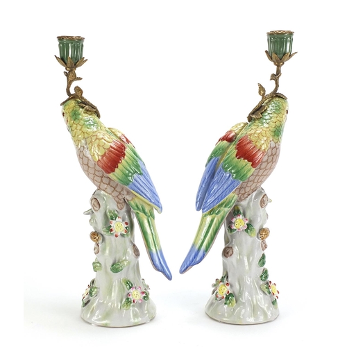 690 - Pair of continental porcelain parrot design candlesticks with bronze mounts, each 36cm high