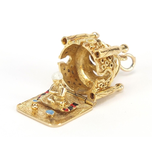 48 - 9ct gold and enamel Taj Mahal charm opening to reveal a praying figure, 2.2cm high, 10.2g