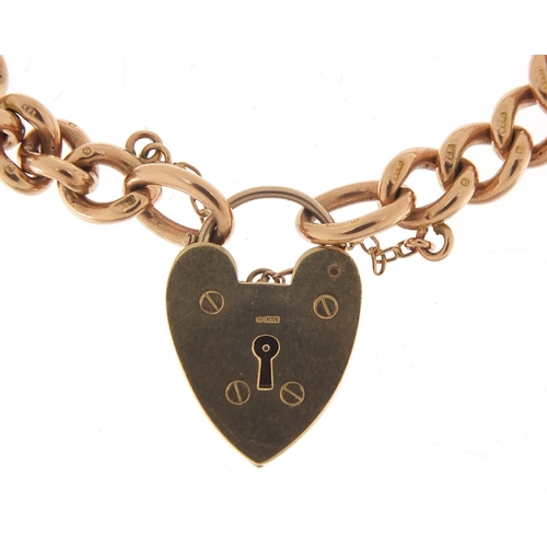 216 - 9ct rose gold charm bracelet with love heart padlock, 18cm in length, 26.5g