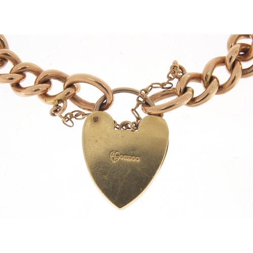 216 - 9ct rose gold charm bracelet with love heart padlock, 18cm in length, 26.5g