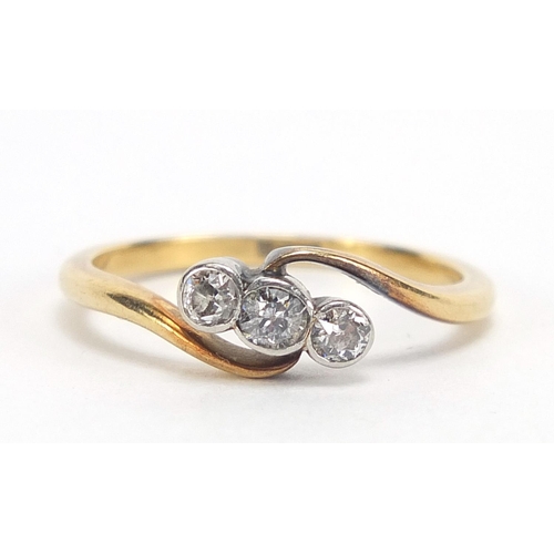 411 - 18ct gold diamond three stone crossover ring, size L, 2.3g