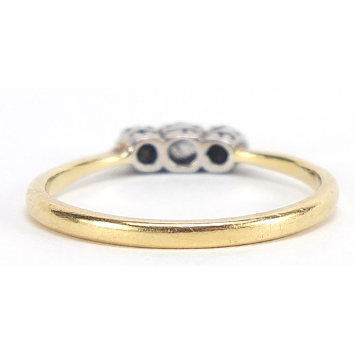 169 - 18ct gold diamond three stone ring, size R, 2.8g