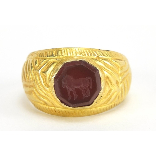16 - Antique unmarked gold intaglio seal ring carved with a horse, (tests as 15ct+) size U, 5.6g