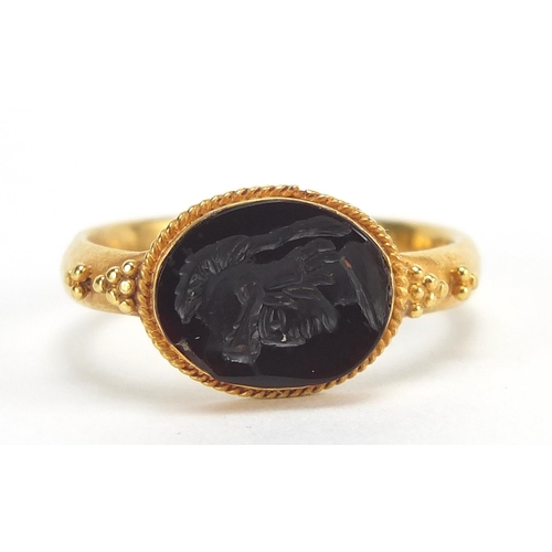 56 - Antique unmarked gold intaglio seal ring carved with a gladiator head, (tests as 15ct+ gold) size Q,... 