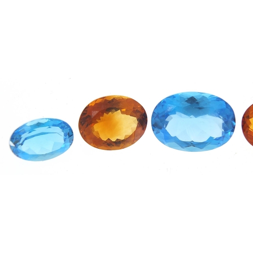 100 - Five gem stones comprising three blue sapphires and two citrine, the largest 18mm x 13mm x 8.5mm dee... 