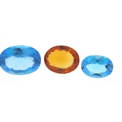 100 - Five gem stones comprising three blue sapphires and two citrine, the largest 18mm x 13mm x 8.5mm dee... 