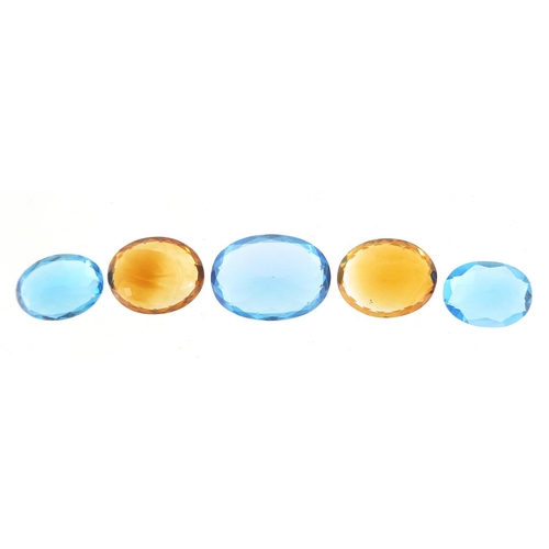 100 - Five gem stones comprising three blue sapphires and two citrine, the largest 18mm x 13mm x 8.5mm dee... 