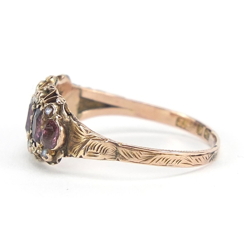 331 - Victorian 9ct gold amethyst and seed pearl ring with ornate setting and chased band, housed in an M.... 