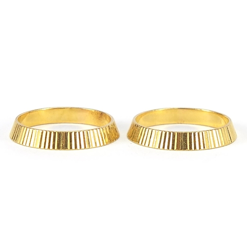 220 - Two 22ct gold wedding bands with engine turned decoration, size J/K, 5.0g