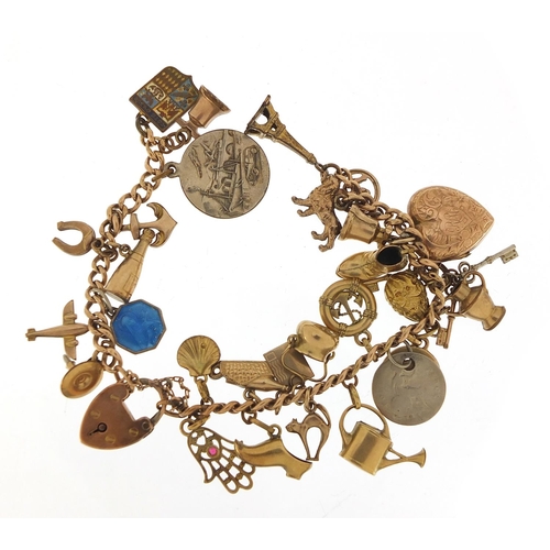 94 - 9ct gold charm bracelet with a selection of gold and metal charms including watering can, hand of Fa... 