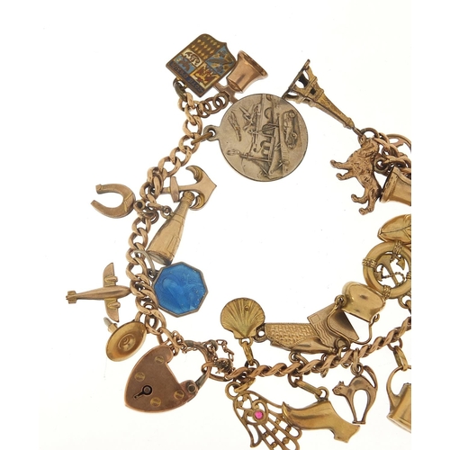 94 - 9ct gold charm bracelet with a selection of gold and metal charms including watering can, hand of Fa... 