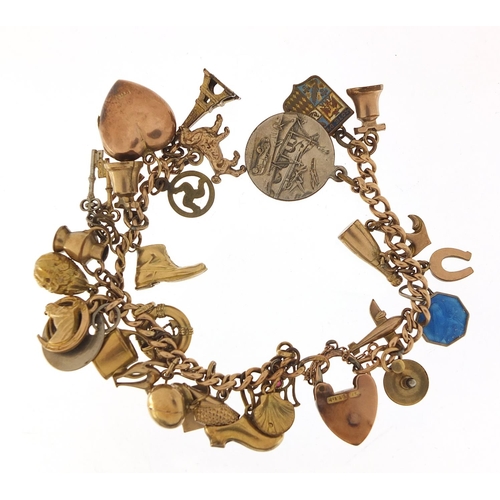 94 - 9ct gold charm bracelet with a selection of gold and metal charms including watering can, hand of Fa... 