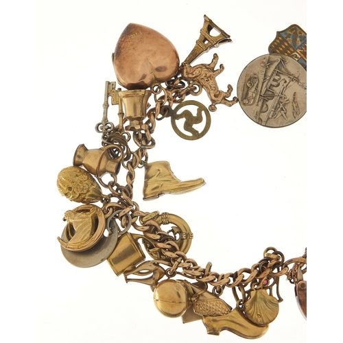 94 - 9ct gold charm bracelet with a selection of gold and metal charms including watering can, hand of Fa... 