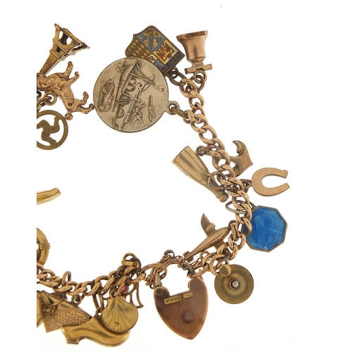 94 - 9ct gold charm bracelet with a selection of gold and metal charms including watering can, hand of Fa... 