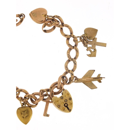 340 - 9ct rose gold charm bracelet with a selection of gold and metal charms including love heart padlock,... 