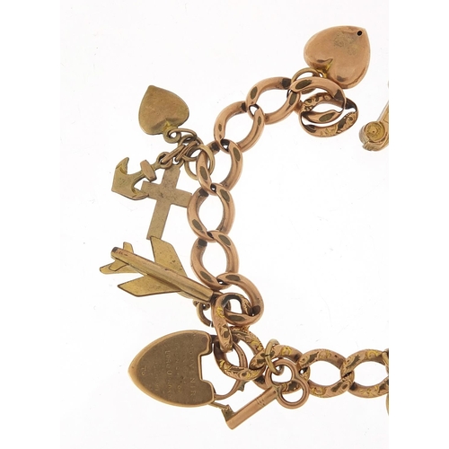 340 - 9ct rose gold charm bracelet with a selection of gold and metal charms including love heart padlock,... 