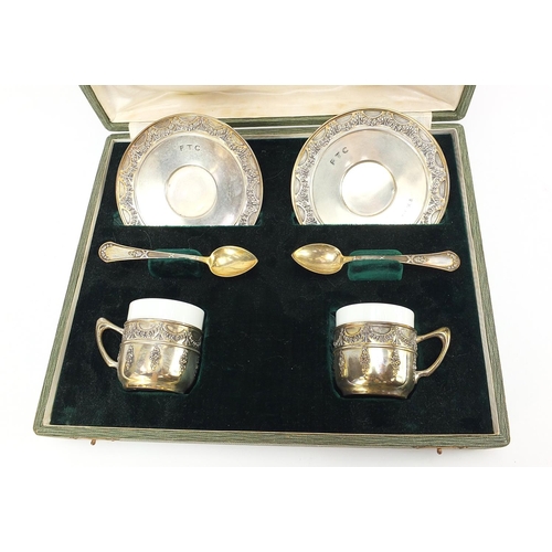 771 - Olympic interest pair of silver cups and saucers with teaspoons, previously owned by George Nicol, 4... 