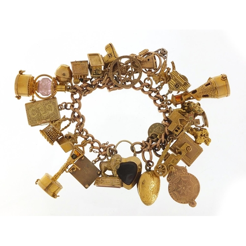 151 - Good 9ct gold charm bracelet with a large selection of mostly gold charms including agate love heart... 