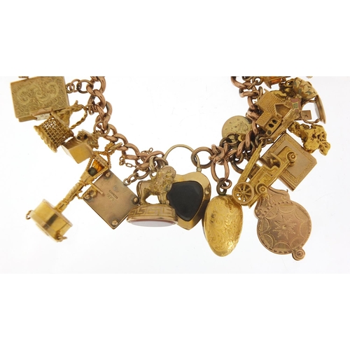 151 - Good 9ct gold charm bracelet with a large selection of mostly gold charms including agate love heart... 