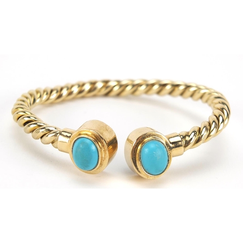 275 - Unmarked gold rope twist and cabochon turquoise bangle, (tests as 15ct+ gold) 6.5cm wide, 13.5g