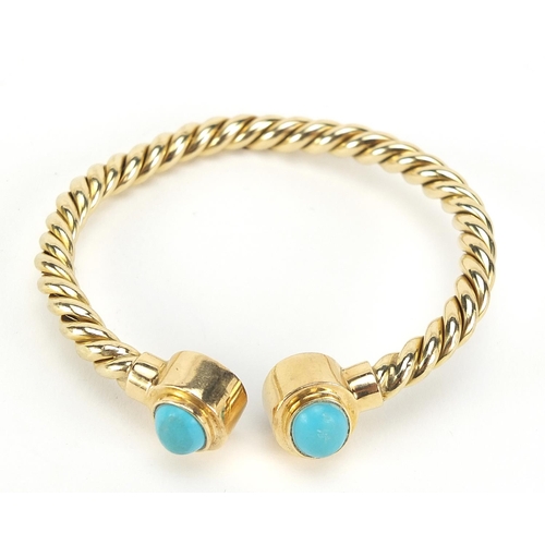 275 - Unmarked gold rope twist and cabochon turquoise bangle, (tests as 15ct+ gold) 6.5cm wide, 13.5g